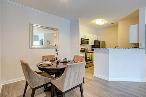 a dining room with a table and chairs next to a kitchen at Thornberry Apartments, Charlotte, NC